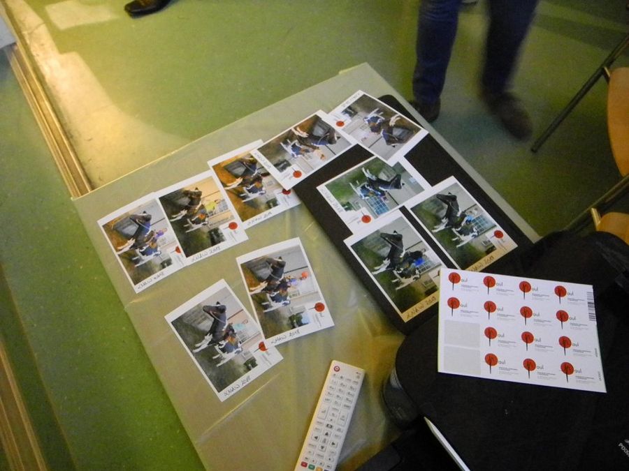 enlarge the image: View of the printed photos and PAUL-sticker at a table